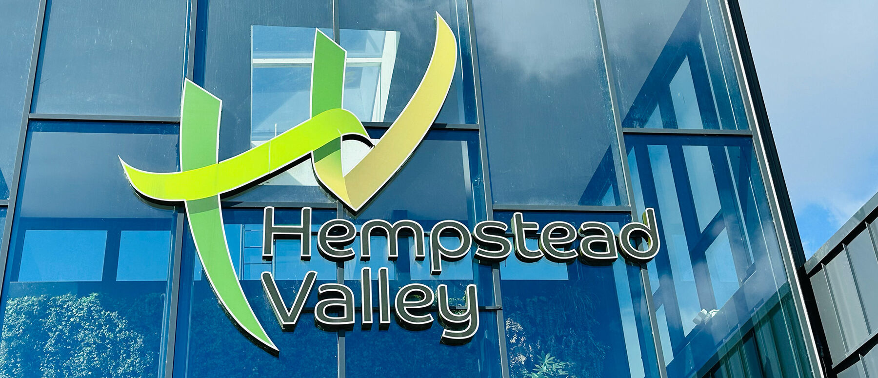 Hempstead Valley's logo displayed on the outside of their glass entrance way.
